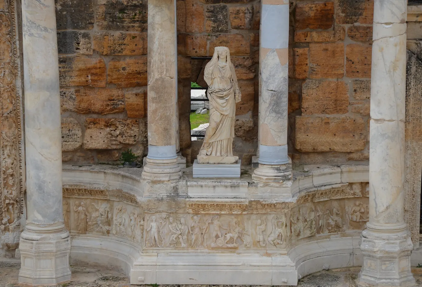 Columns, sculpture and carved reliefs on the stage building of the Hierapolis theatre