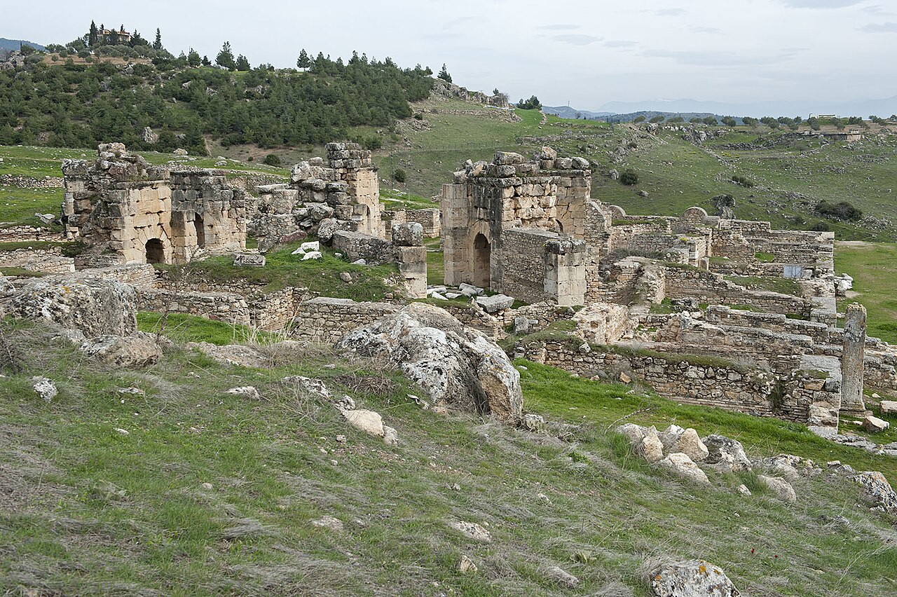 Low stone walls and surviving arches of the octagonal St Philip Martyrium on the Hierapolis hillside